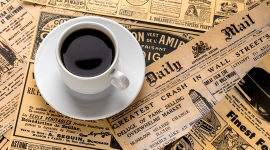 Cup of coffee on top of Daily Mail newspaper