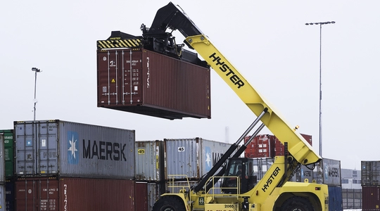 heavy lifting machine lifting a cargo box or shipping container