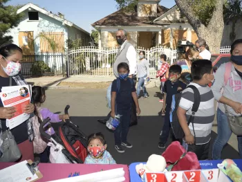 Councilmember Curren Price and children at fair