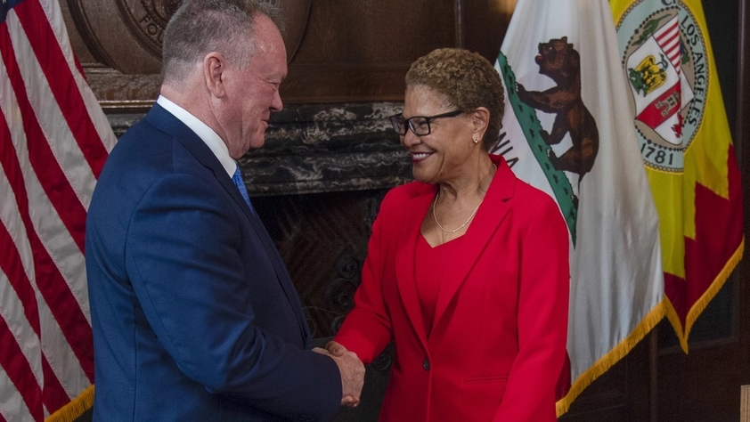Mayor Karen Bass shaking hands with LAPD Chief Jim McDonnell